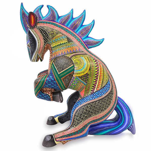 A colorful, hand-painted wooden Native American-style horse figurine with intricate geometric patterns in blue, green, yellow, orange, and black, set against a plain white background.
