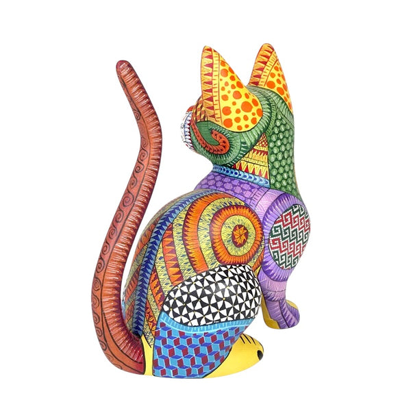 Oaxaca alebrije cat figurine with geometric patterns on a white background