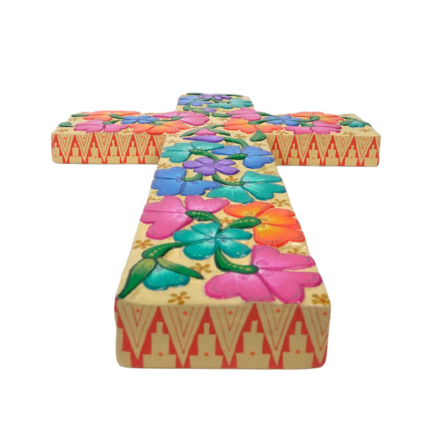 Decorative cross with colorful floral patterns on a white background