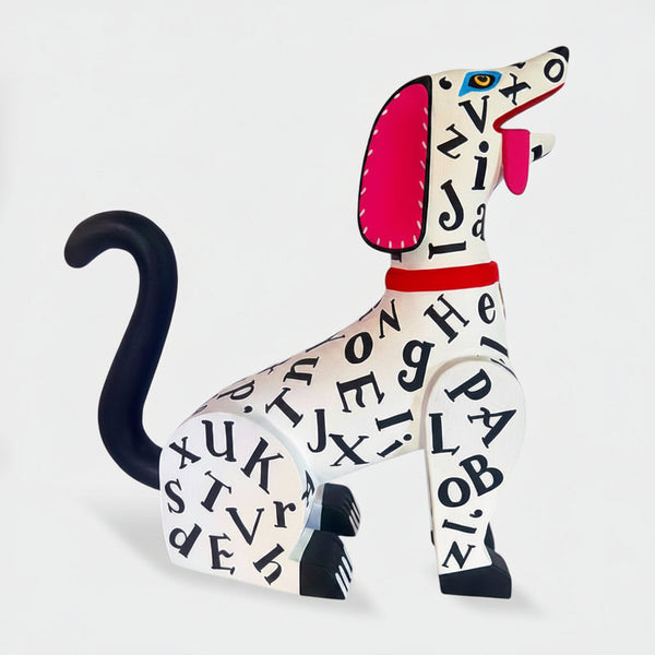 Colorful dog alebrije with calligraphy alphabet letters on a white background