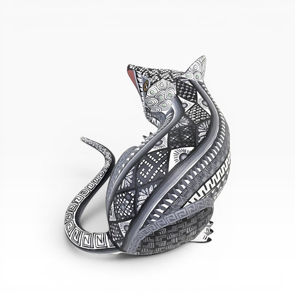 Decorative wood mouse hand carved in Mexico with intricate patterns on a white background
