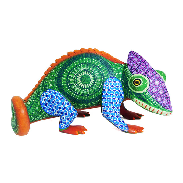A colorful wooden sculpture of a chameleon with a detailed and patterned design, featuring vibrant green, blue, and purple colors, with patterns of a spiral and geometric shapes on its body.