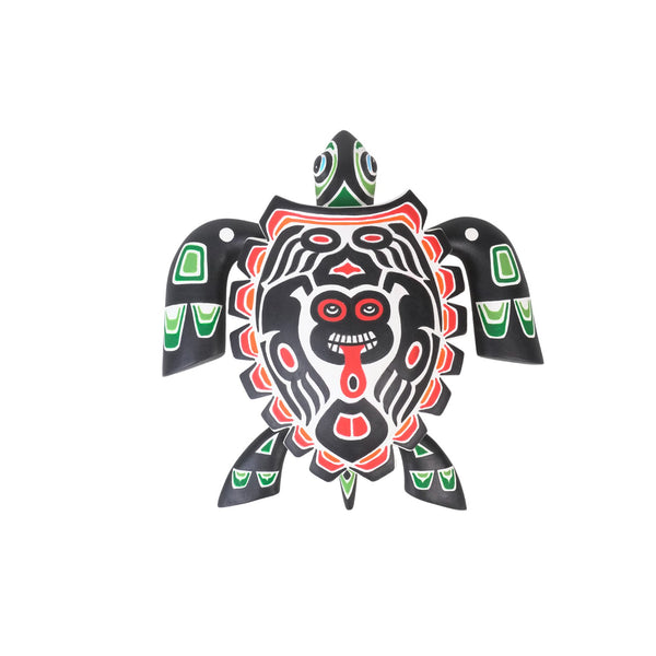 Original Alebrije turtle figurine with black, red, and green design on a white background. Authentic Oaxacan woodcarving.