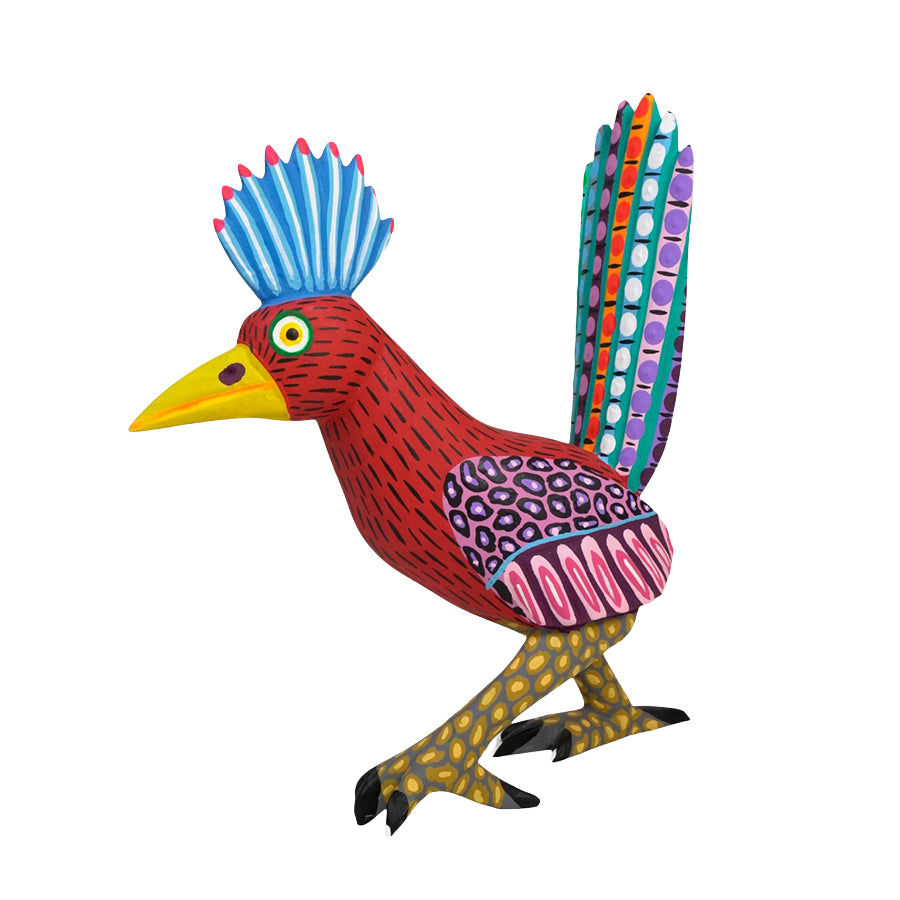 Mexican Folk Art wood figurine of a roadrunner with a blue head and multicolored tail on a white background