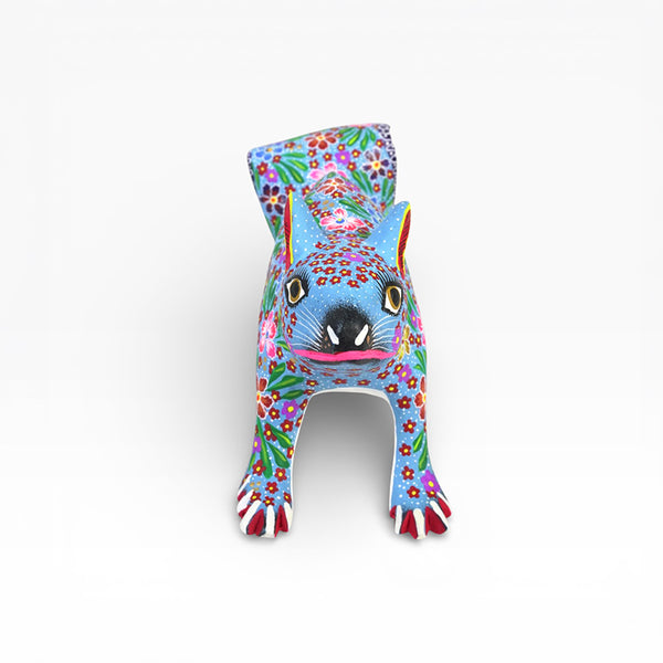 Colorful alebrije wood Squirrel with floral patterns on a white background