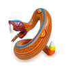 Rattlesnake Alebrije sculpture hand carved and hand painted. Zapotec fretwork design in delicate orange, yellow and blue