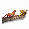 Two colorful Jaguar alebrijes made from copal wood on a wooden branch against a white background