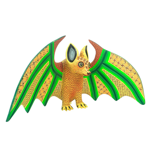 Authenti alebrije figurine of a bat with green wings on a white background