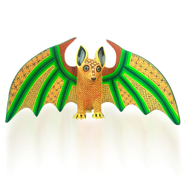 Original alebrije bat figurine with green and orange wings on a white background