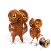 Two copper wire owl sculptures with large yellow and black eyes, shown on a white background with a spool of copper wire.