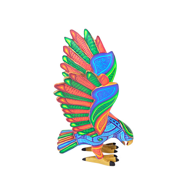 Eagle figurine made from copal wood with intricate color patterns on a white background