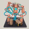 Antonio Alonso papier-mâché sculpture of an axolotl emperor and four musicians around a turquoise tree, on a warm gray background.