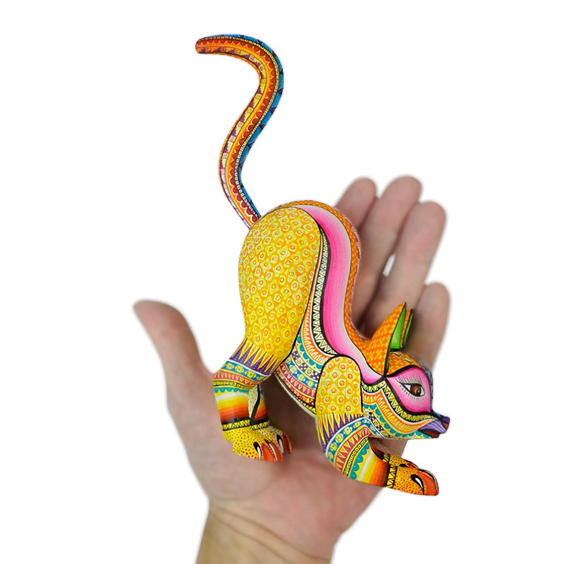 Colorful Oaxacan alebrije woodcarving cat stretching, hand-carved and painted.