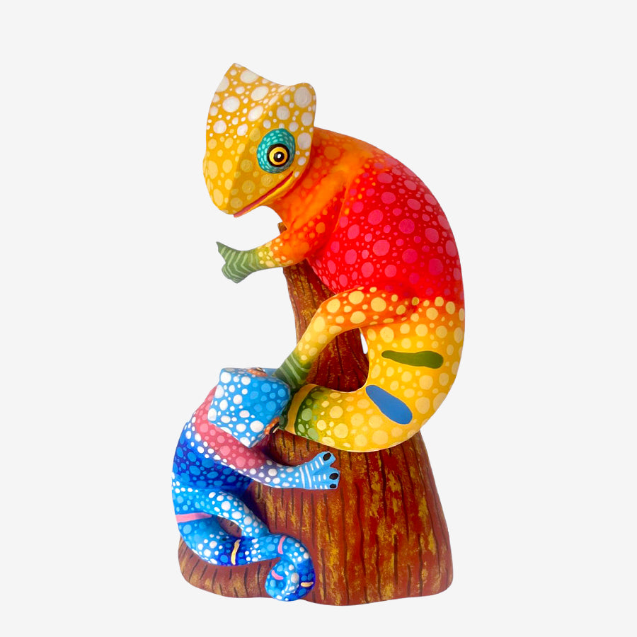 Colorful chameleon wood carved figurine from Oaxaca on a white background
