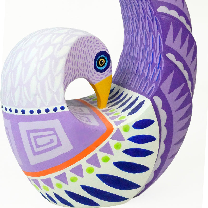 Authentic dove Alebrije sculpture with purple and blue patterns on a white background