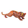 Colorful wild cat Alebrije wood figurine on a white background