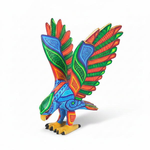 Hand carved eagle figurine with open wings on a white background