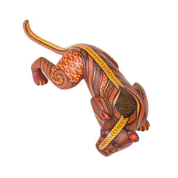 Original Handcarved wooden sculpture of a stylized Jaguar with intricate patterns on a white background