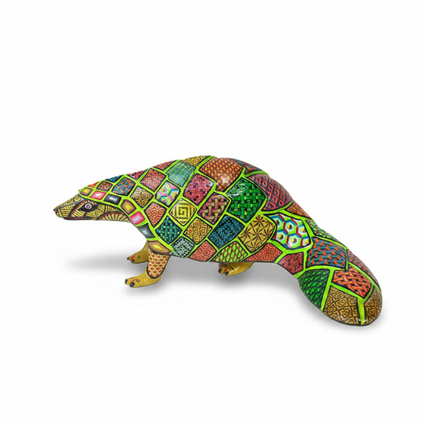 Colorful pangolin wood figurine with geometric pattern on a white background