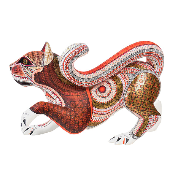 Hand-carved copal wood cat figurine with intricate patterns on a white background