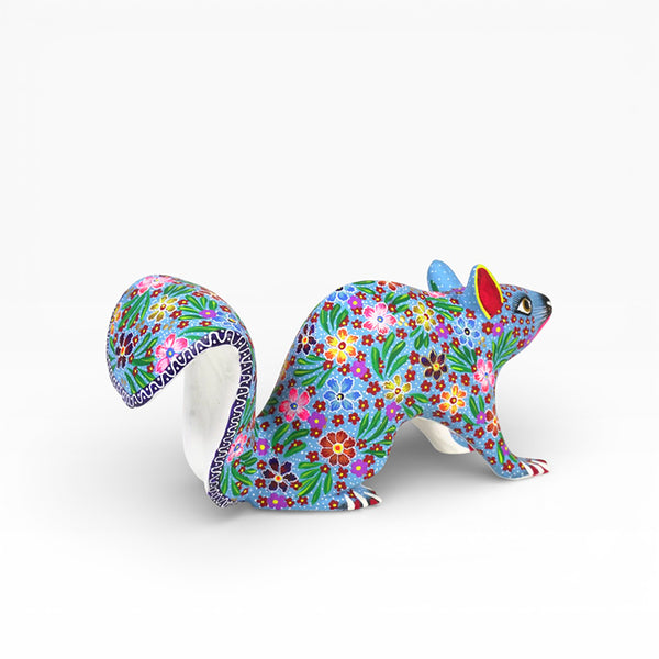 Colorful alebrije  floral-patterned squirrel figurine on a white background