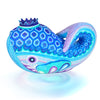 Colorful whale Alebrije wood carving with geometric patterns on a white background